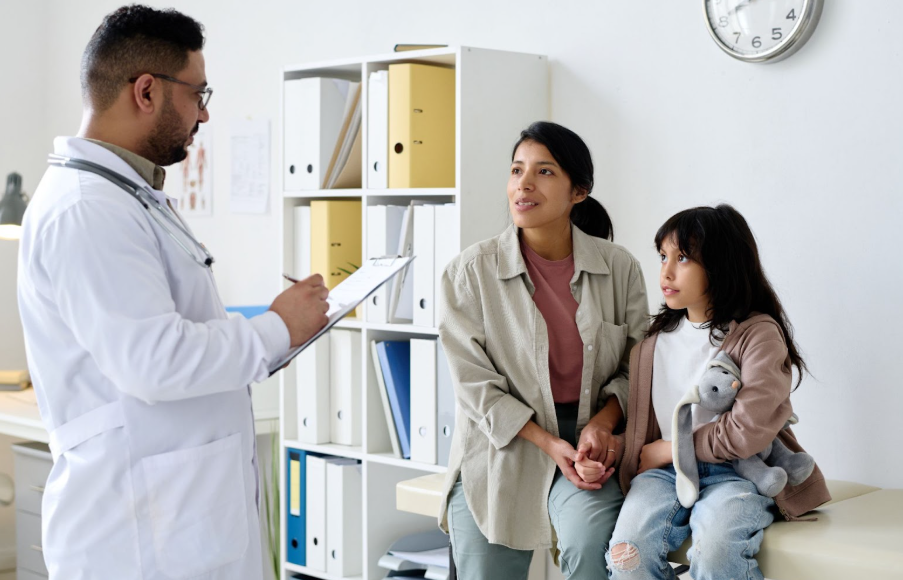 Childhood cancer survivor and parent advocating at a medical appointment